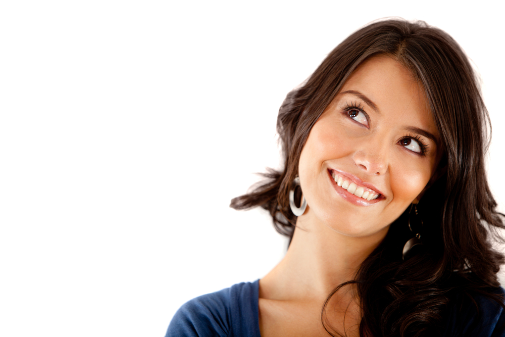 Beautiful thoughtful woman looking up - isolated over white